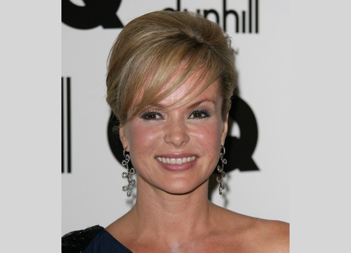 Amanda Holden's hair in a smooth updo | Long earrings increase the length  of her neck