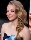 Amanda Seyfried wearing her hair over one shoulder and in a braided ponytail