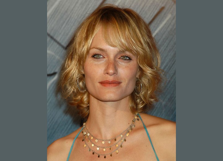 Amber Valletta sporting a medium length hairstyle with curls