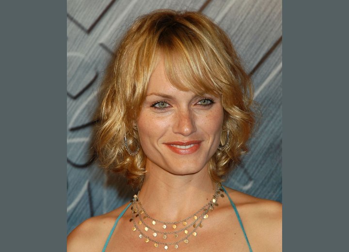 Amber Valletta with semi short curled hair