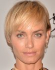 Amber Valletta wearing her hair short in a pixie with bangs