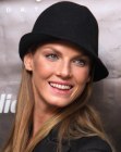 Angela Lindvall sporting long straight hair paired with a hat