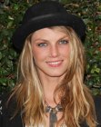 Angela Lindvall with long layered hair and a derby hat