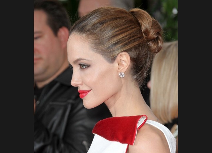 Angelina Jolie's hair styled into a simple and elegant up 