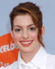 Anne Hathaway with her hair in a youthful ponytail featuring a loose strand