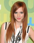 Ashlee Simpson with her long red hair styled for a sleek appearance