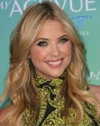 Ashley Benson sporting long dark blonde hair with highlights and curls