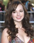 Ashley Rickards sporting long brown hair with spiral curls