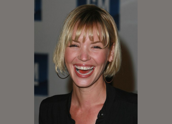 Ashley Scott wearing a collarless shirt that makes her hair look shorter