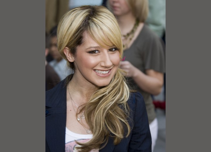 Ashley Tisdale wearing her hair with a side ponytail