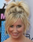 Ashley Tisdale with her hair styled into a wild updo