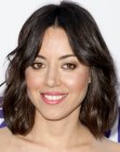 Aubrey Plaza sporting an above the shoulders hairstyle with layers and split bangs