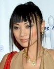 Bai Ling sporting a hairstyle with a high ponytail and loose strands