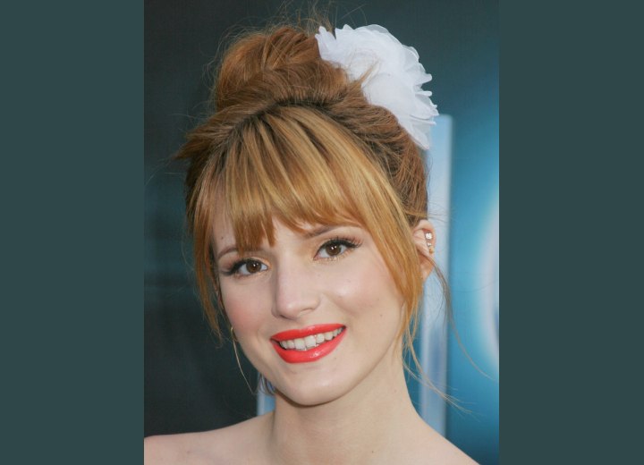 Bella Thorne - Top knot hairstyle addorned with a flower