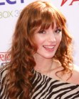 Bella Thorne's long red hair with bangs and spiral curls