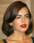 Camille Belle's 1950s inspired medium length hairstyle with side bangs