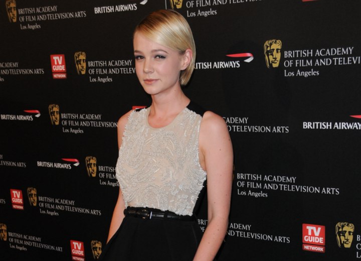 Carey Mulligan with her hair cut in a bob and wearing a black skirt