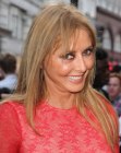 Carol Vorderman aged past 50 and wearing her hair long and youthful