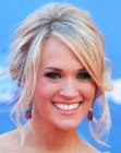 Carrie Underwood wearing her hair in a loose updo with side tendrils