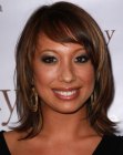 Cheryl Burke wearing shoulder length hair styled with an outward curve