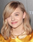 Chloe Moretz sporting a medium length hairstyle with long side bangs