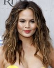 Chrissy Teigen wearing her long ombré hair in a slightly curly style