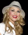 Christie Brinkley wearing a hat on top of her curled hair