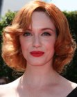 Christina Hendricks sporting a medium length 1950s hairstyle with curls