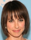 Constance Zimmer with her brown hair cut into a neck length bob