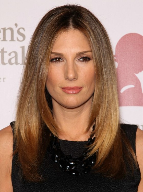 Daisy Fuentes with long smooth hair that is divided into 