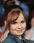 Debby Ryan wearing her hair up in a top knot