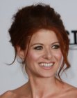 Debra Messing wearing her hair in a messy up style