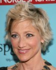 Edie Falco with her hair cut short in a hairstyle with layers