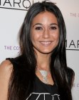 Emmanuelle Chriqui wearing her black hair in a sleek style with a middle part
