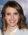 Emma Roberts sporting a professional long hairstyle with waves