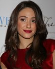 Emmy Rossum wearing her brown hair long with curls