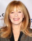 Frances Fisher's long hairstyle with layers and ends that flip out and up