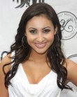 Brunette Francia Raisa sporting long curls that fall below her shoulders