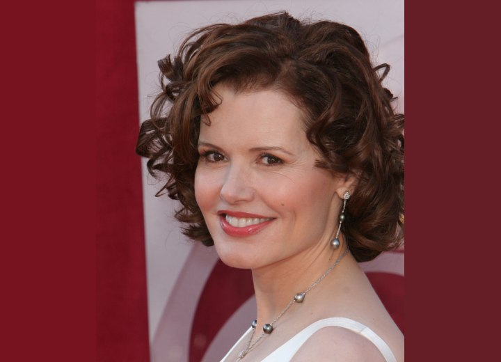 Side view of Geena Davis medium hairstyle with curls