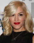 Gwen Stefani's medium long hair with curls around her shoulders