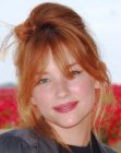 Redhead Haley Bennett's up-style with loose tendrils