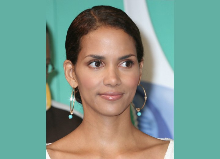 Halle Berry with her hair pulled back and bound in a bun