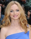 Heather Graham wearing her long hair styled into lazy spiral curls
