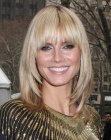 Heidi Klum's long hairstyle with bangs that draw attention to the eyes