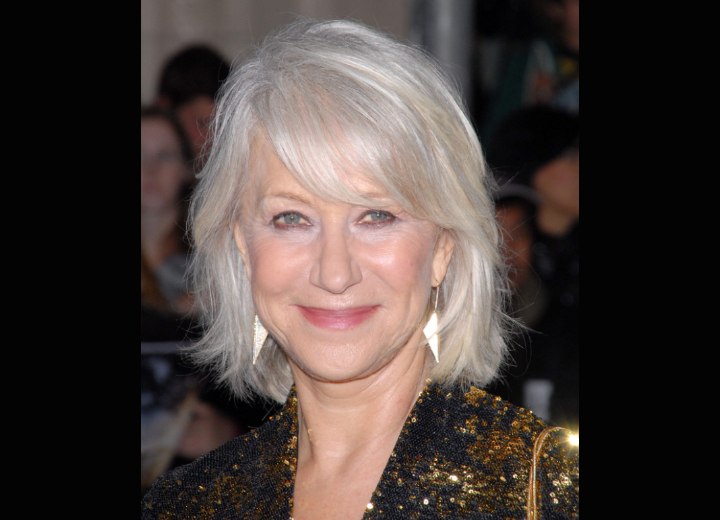 Helen Mirren with her silver white hair in a style that touches the collar