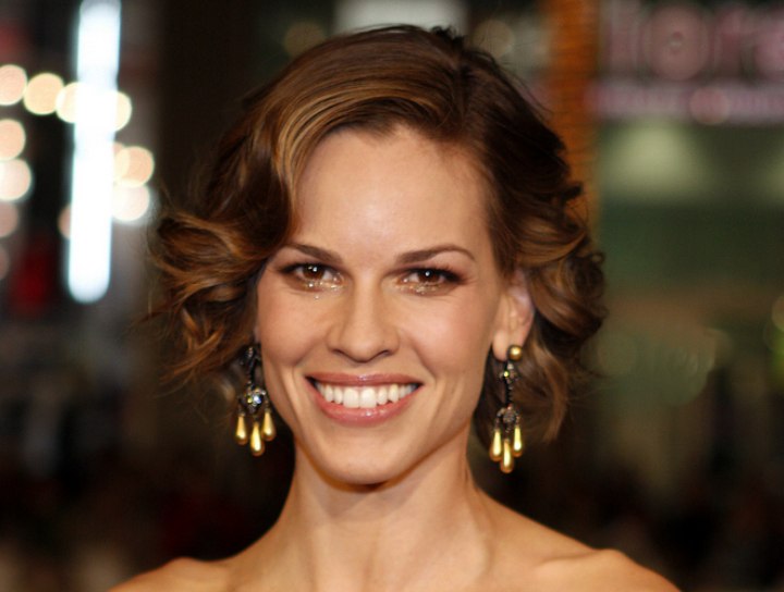 Hilary Swank's hair in a bouncy curly bob