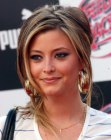 Holly Valance's updo with a bun and loose strands that frame her face