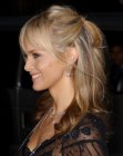 Izabella Scorupco wearing her hair up with a semi ponytail