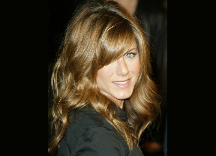 Jennifer Aniston with her hair styled in curls
