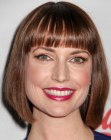 Julie Ann Emery wearing her hair in a tilted bob with above the eyebrows bangs
